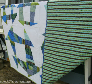 front and back of quilt liberated churn dash quilt