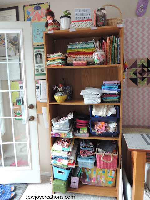 organized quilt room bookcase fabric display