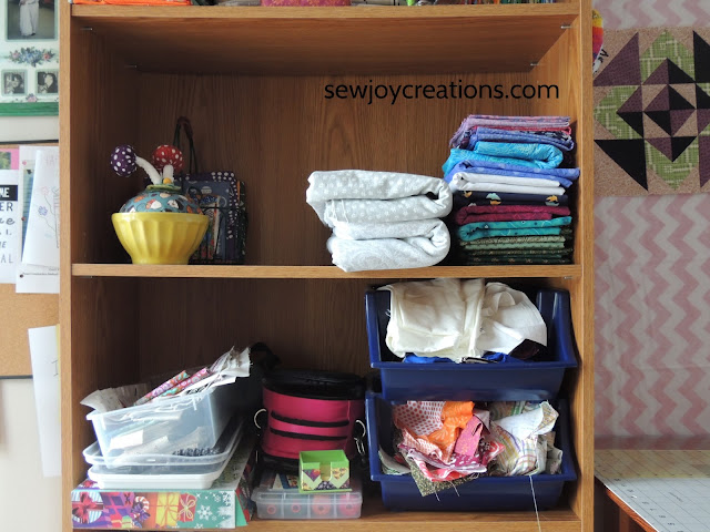 sewing room bookcase folded fabric scrap bins