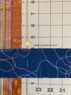Put a Pin in It! Tip for cutting long strips of fabric with a cutting mat